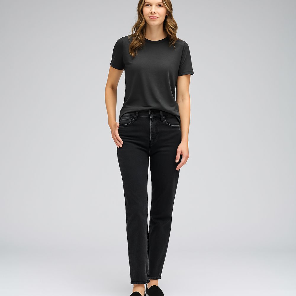 Full body view of woman wearing black tech T-shirt – minimalist fit and breathable performance fabric